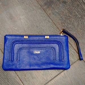 Cloe clutch. Royal Blue in Caviar leather with gold medal details.